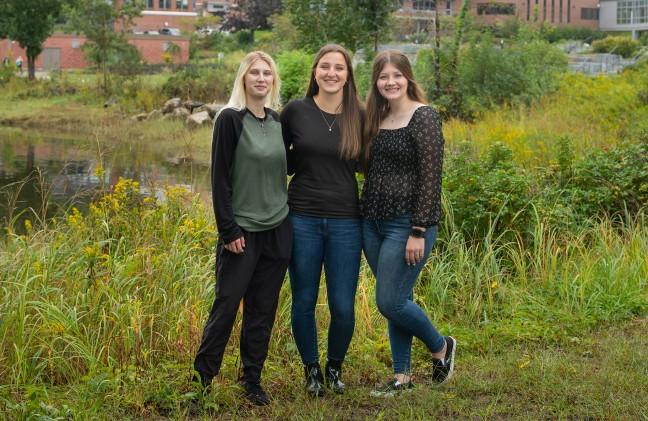 The three Davis Maine Scholarship winners stand in the grass